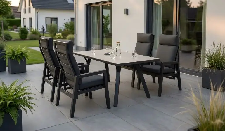 Gartengarnitur Aluminium Alicante, dunkelgraue Hochlehner mit grauen Polstern und Tisch mit heller Platte auf Terrasse